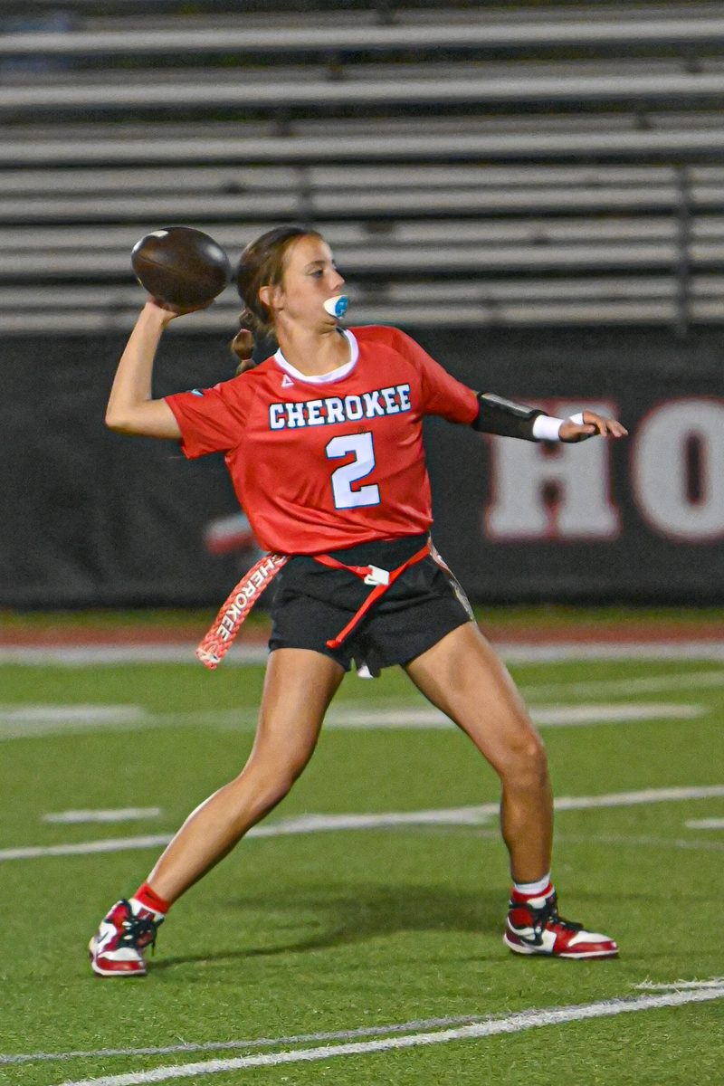 High school flag football quarterback number 2 throwing a pass