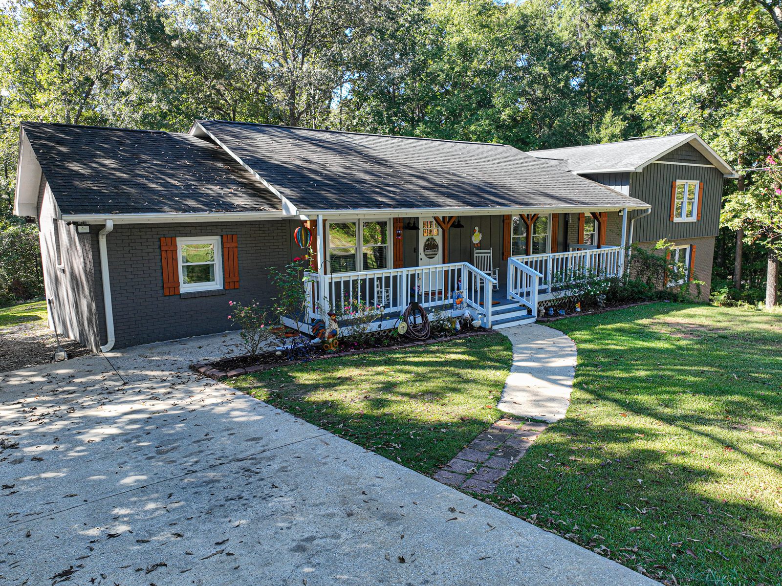 Brick ranch house in Centreville Alabama with a covered front porch and a walkway across the lawn